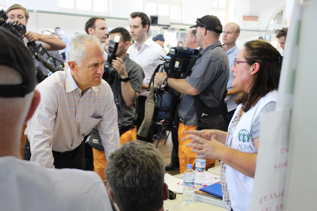 Prime Minister Malcolm Turnbull listens to ADRA volunteer Sonya Watts. [Credit: Ian Campbell, About Regional]