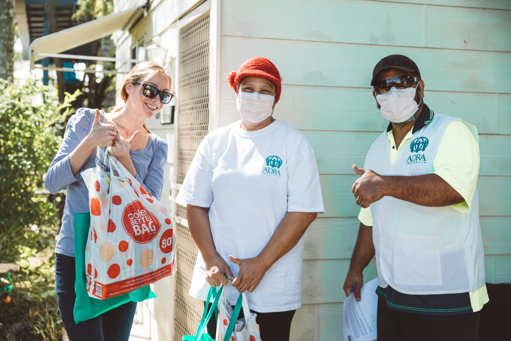 Three ADRA volunteers delivering food packages
