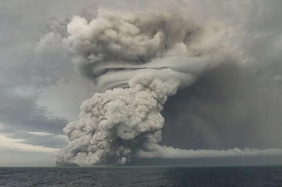ADRA's Tonga Response - A giant ash cloud exploding into the sky, surrounded by ocean