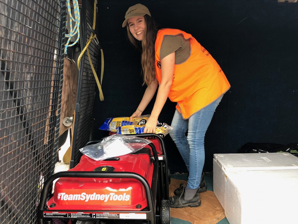ADRA volunteer Anna helping to pack generators